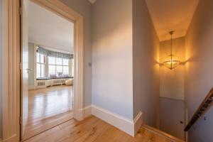 an empty hallway with a door and a light fixture at Boycott House in Cromer +33 photos