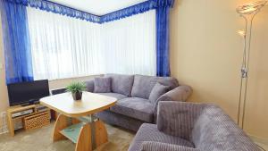 a living room with a couch and a table at Stettiner Str 6b in Grömitz