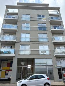 a white car parked in front of a building at R Haus 2 Con Cochera in Concordia