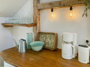 a counter with a coffee maker and other items on it at Apartment In A Converted 1875 Creamery in Travenhorst