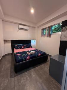 a small bedroom with a bed in a room at Logan Apartments in Bantayan Island