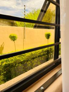 a view from a window of a field of flowers at Aurum Stays in Gaborone