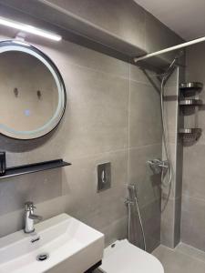 a bathroom with a sink and a mirror and a shower at Tousso Apartment Loggos in Longós