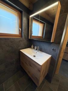 a bathroom with a sink and a mirror at Le mazot in Lens +4 photos
