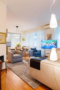 a living room with a couch and a tv at Como Prestige Centro Apartment By Icon7 Luxury in Como
