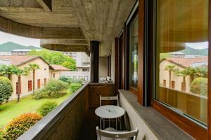a balcony with a table and chairs and a window at Como Prestige Centro Apartment By Icon7 Luxury in Como