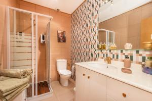 a bathroom with a toilet and a sink and a shower at Casa Francisco y Carmen in Alfarrás +19 photos