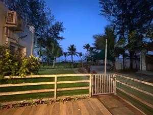 a wooden fence in front of a house at Waves - for Family & Married Couples only in Mahabalipuram