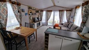a small living room with a table and a couch at Devon holiday in Goodrington