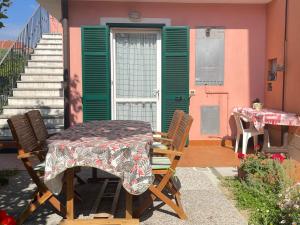 a table and chairs in front of a house at Casa Mare Blu codice CITRA OO9O34 LT 1168 in Loano