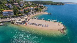 a group of people on a beach in the water at Donna Seahouse in Jadranovo