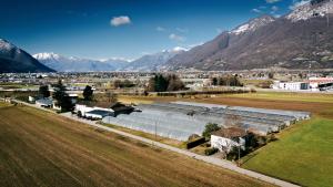 an aerial view of a farm with mountains in the background at Agriturismo Regusci in Camorino