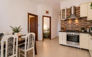 a kitchen with a table and a dining room at Apartman Ivana in Kruševo +2 photos