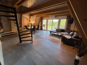 a living room with a staircase and a couch at Dachzelt Oase Damp in Damp