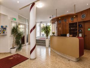 a lobby with a reception desk and a christmas pole at Turmhotel Rhein-Main - klimatisierte Apartments in Dreieich
