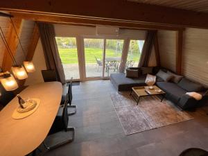 a living room with a couch and a table at Dachzelt Oase Damp in Damp