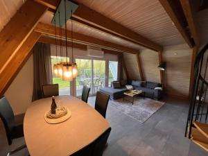 a living room with a table and a couch at Dachzelt Oase Damp in Damp