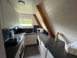 a small kitchen with a sink and a stove at Dachzelt Oase Damp in Damp +38 photos