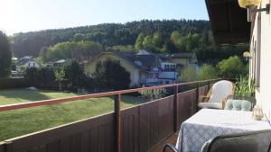 a balcony with a table and a view of a house at Tildes Apartments in Reifnitz