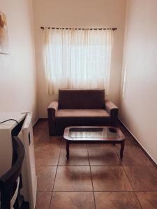 a living room with a couch and a coffee table at Arpini Hotel in Rio Grande +43 photos