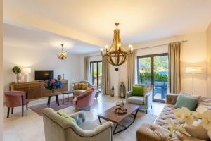 a living room filled with furniture and a chandelier at Kotor Bay Villas by Huma in Dobrota