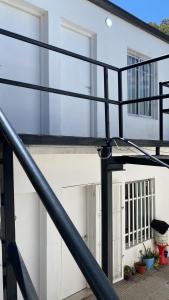 a black spiral staircase in front of a building at Departamentos Belgrano in San Luis