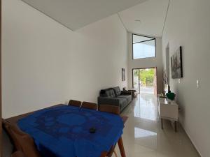 a living room with a table and a couch at Casa moderna em Itapoá SC in Itapoa