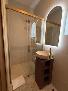 a bathroom with a sink and a shower at DomaineduRocBlanc in Merey