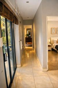 a hallway of a home with glass doors and a living room at Villa on Ibis in Cape Town +38 photos