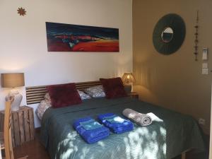 a bedroom with a bed with two trays on it at Villa la Roseraie chambre avec sdb privée in Montpellier