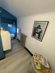 a room with a table and a picture on the wall at Comme à la maison B and B - 2 chambres et 1 salon in Carcassonne