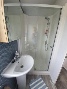 a bathroom with a sink and a shower at Devon holiday in Goodrington +23 photos
