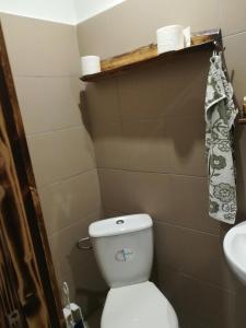 a small bathroom with a toilet and a sink at Hotel Garni in Liptovský Mikuláš