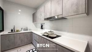 a kitchen with a stove and some pots and pans at Enclave Nature Suites Bukit Tinggi by BYON in Bentong +233 photos