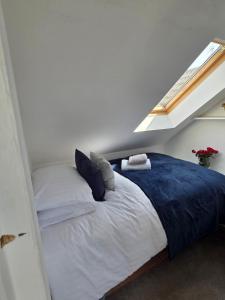 a bedroom with a bed in a room with a window at The Fox Apartment LBA in Horsforth