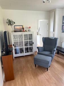 a living room with a chair and a television at Summerhouse by the ocean in Drangsnes