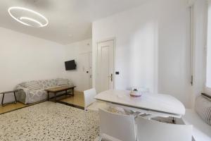a white living room with a table and chairs at Beautifulliguria in Sestri Levante