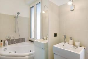 a white bathroom with a tub and a sink at Beautifulliguria in Sestri Levante +33 photos
