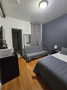 a hotel room with two beds and a television at Shefah Hotel in Union City
