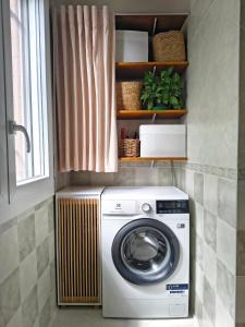 a washing machine in a kitchen with a window at B&B La stanza del sole in Modena