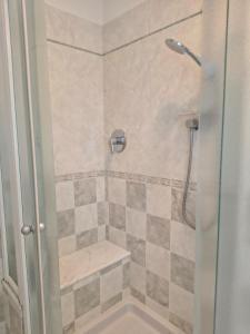 a bathroom with a shower with a glass door at B&B La stanza del sole in Modena