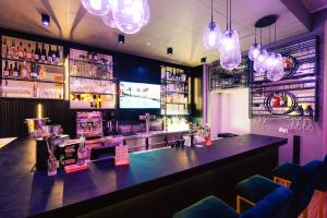 a bar with a large counter in a room at H24 Parkhotel Thale in Thale