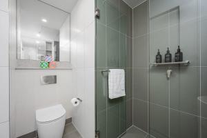 a bathroom with a toilet and a glass shower at LaneStay - 2BR Panoramic Views w Pool Spa & Gym in Melbourne +17 photos