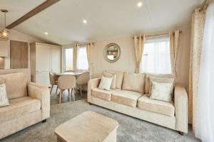 a living room with a couch and a table at Host & Stay - Stag Lodge in Pickering