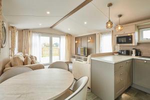 a kitchen and living room with a table and chairs at Host & Stay - Stag Lodge in Pickering +10 photos