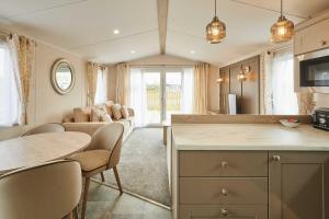 a kitchen and living room with a table and chairs at Host & Stay - Stag Lodge in Pickering