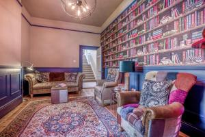 a living room with a large wall of books at 4 Bed in Lyndhurst oc-nfl57 in Lyndhurst