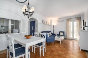 a kitchen and living room with a white table and chairs at Atlantico Atico PLUS by Ĥ - Playa Punta del Moral PAHT76P102 in Isla del Moral