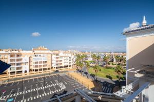 a view of a city from the balcony of a building at Atlantico Atico PLUS by Ĥ - Playa Punta del Moral PAHT76P102 in Isla del Moral