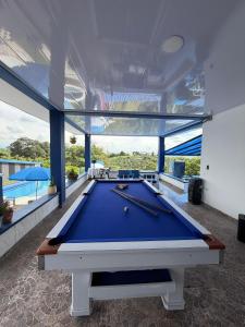 a pool table in a room with a view at Arte Hotel del Quindío in Filandia